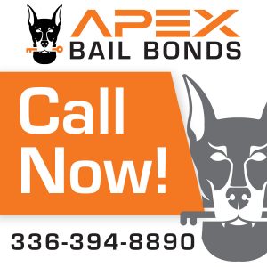 Apex Bail Bonds agent explaining the bail bond process to a family outside a local jail facility in North Carolina.